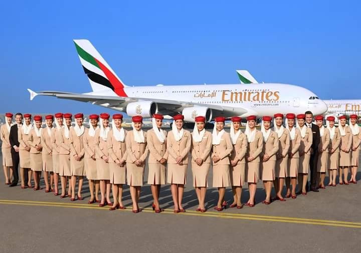 Emirates Group Cabin Crew Jobs, The cabin crew posing in front of Emirates Aircraft