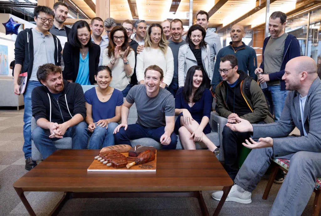 Diverse group of Facebook employees in Dubai, smiling and collaborating